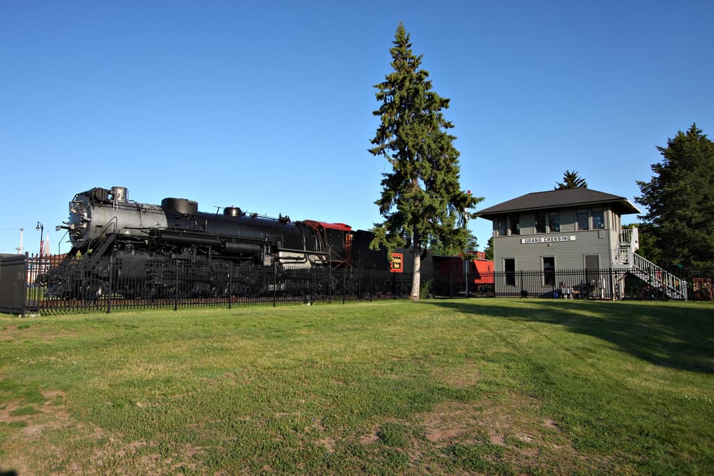 Preserved Aeolus steam locomotive and Grand Crossing tower in Copeland Park