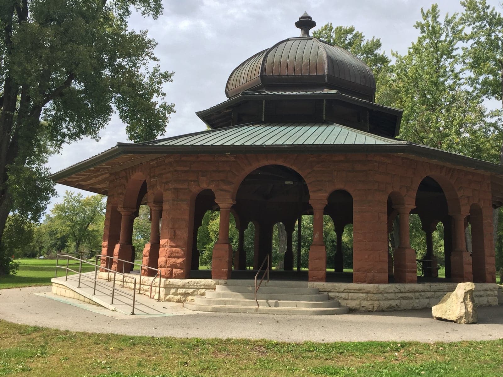 Historic stone shelter with an accessible ramp at Pettibone Park